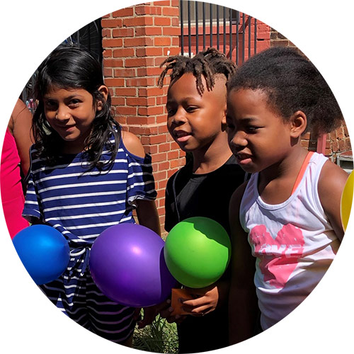 Three kids from the Washington DC Jubilee Housing early start summer program with their balloon-powered Mars landers