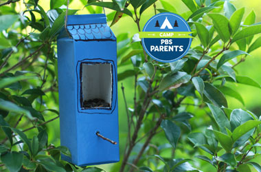 a bird feed made out of a milk carton