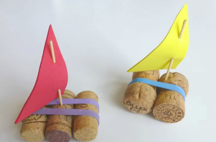 toy boats made from corks and paper