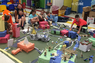 Kids building a model city with cardboard boxes
