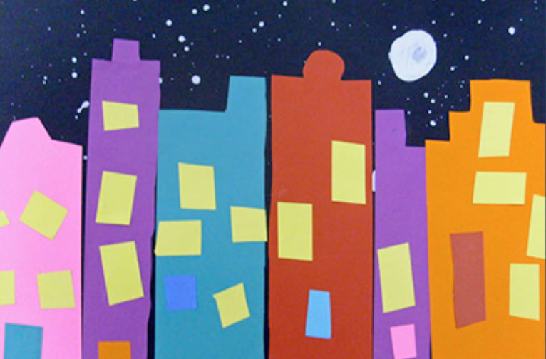 cut paper silhouette of cityscape at night