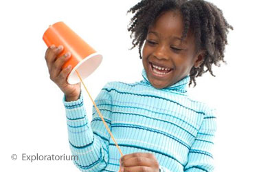girl holding homemade cuica drum 
