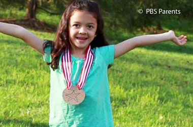 Young girl wearing a homemade gold medal