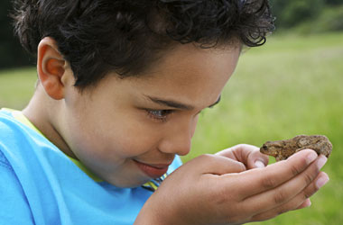 young boy holding small animal
