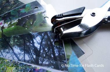 a pile of photos and a hole punch