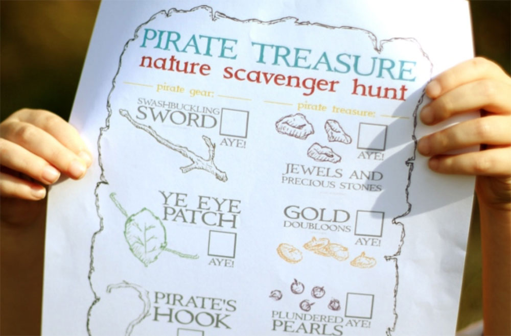Detail of a child holding up a pirate scavenger hunt map