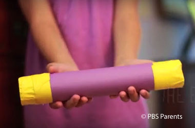 child holding homemade rain stick