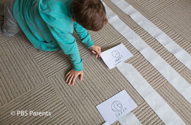 child making a distance scale model of solar system with paper