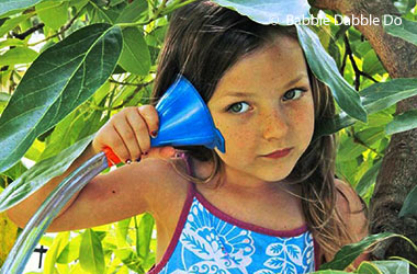 Girl listening to funnel attached to a tube.