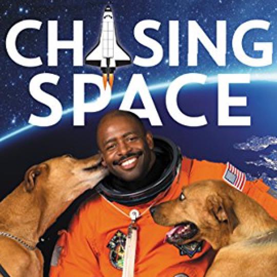 photo cover of Chasing Space showing an astronaut in his space suit and two dogs