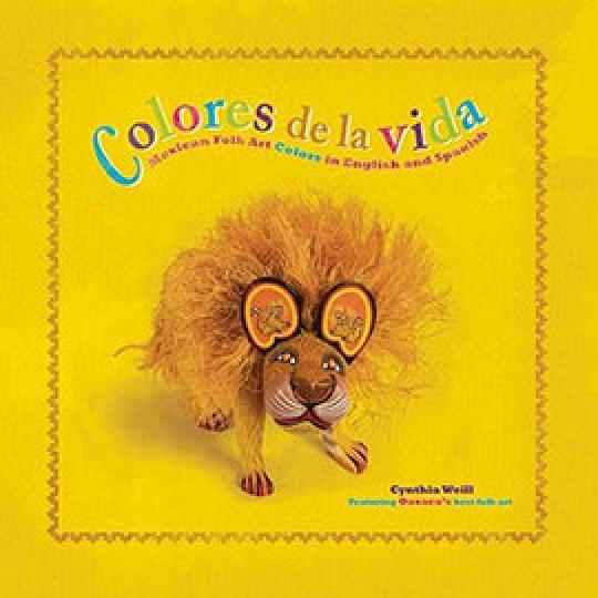 the yellow cover of Colores de la Vida showing a lion figure.