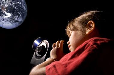 a young girl looking through a telescope