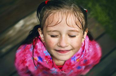 down shot of girl with wet face and hair