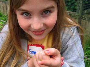 young girl hold bug on her fingertip. young girl hold bug on her fingertip.