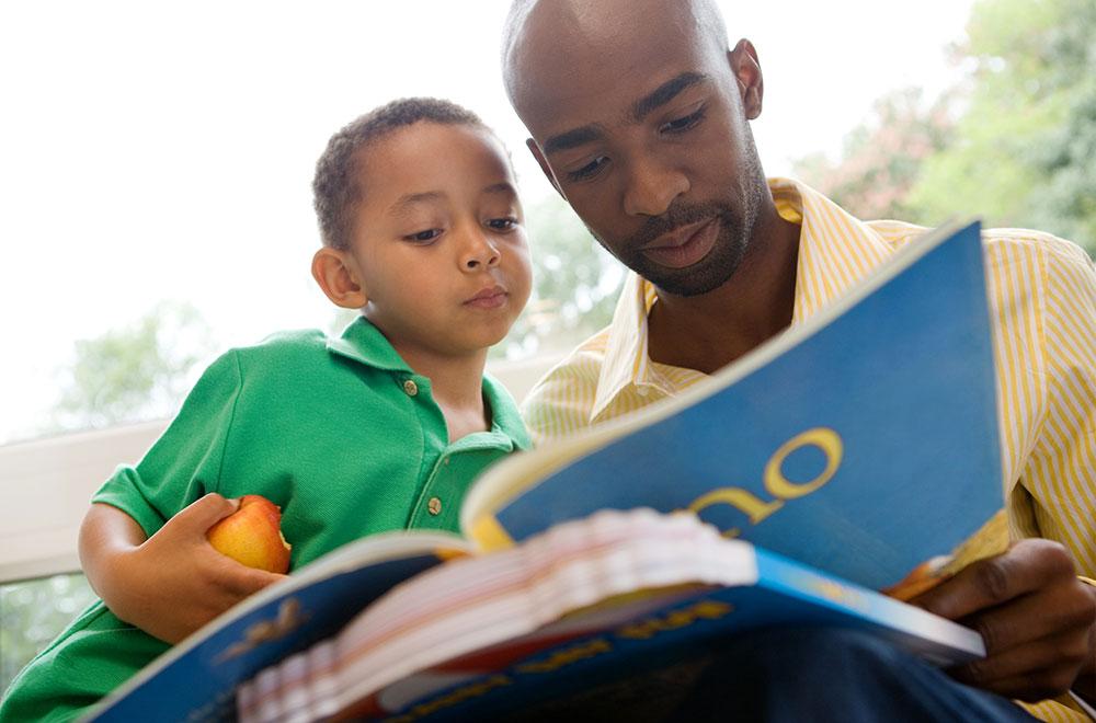 Father and son reading together