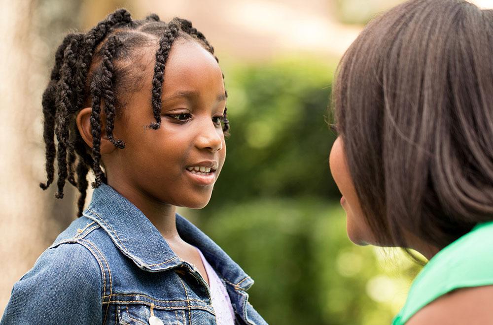 Mother having a conversation with elementary-aged daughter