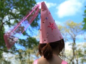 young child in a princess cone cap.