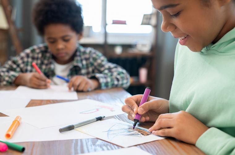 two young children creating homemade books