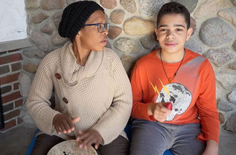 Mother and son doing call and response with drum