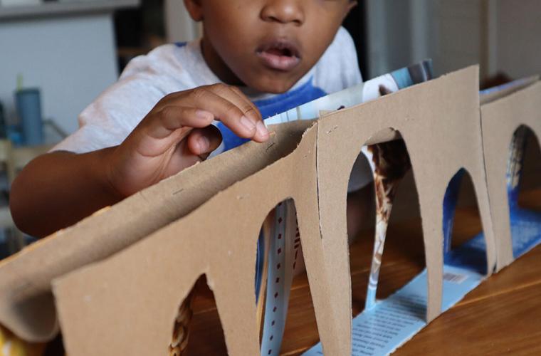 child building a cardboard aqueduct