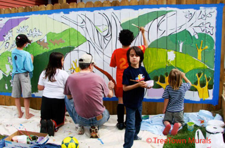 photo of children painting a mural