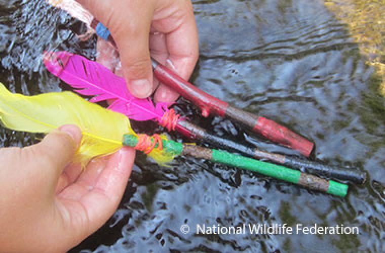 Three sticks with colorful feathers on the ends.