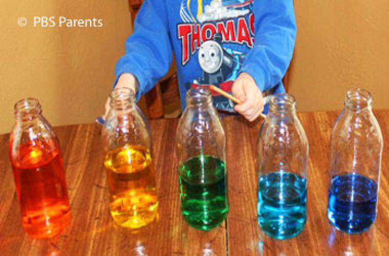 Child playing a DIY water xylophone