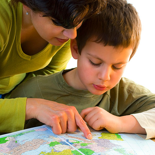Woman looking at a world map with a child.